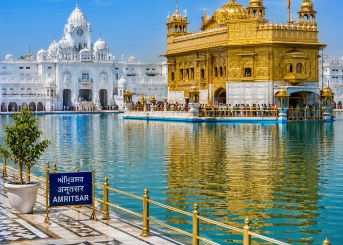 Amritsar Golden Temple with sacred pool reflections, Sikh architecture and clear morning daylight in Punjab.