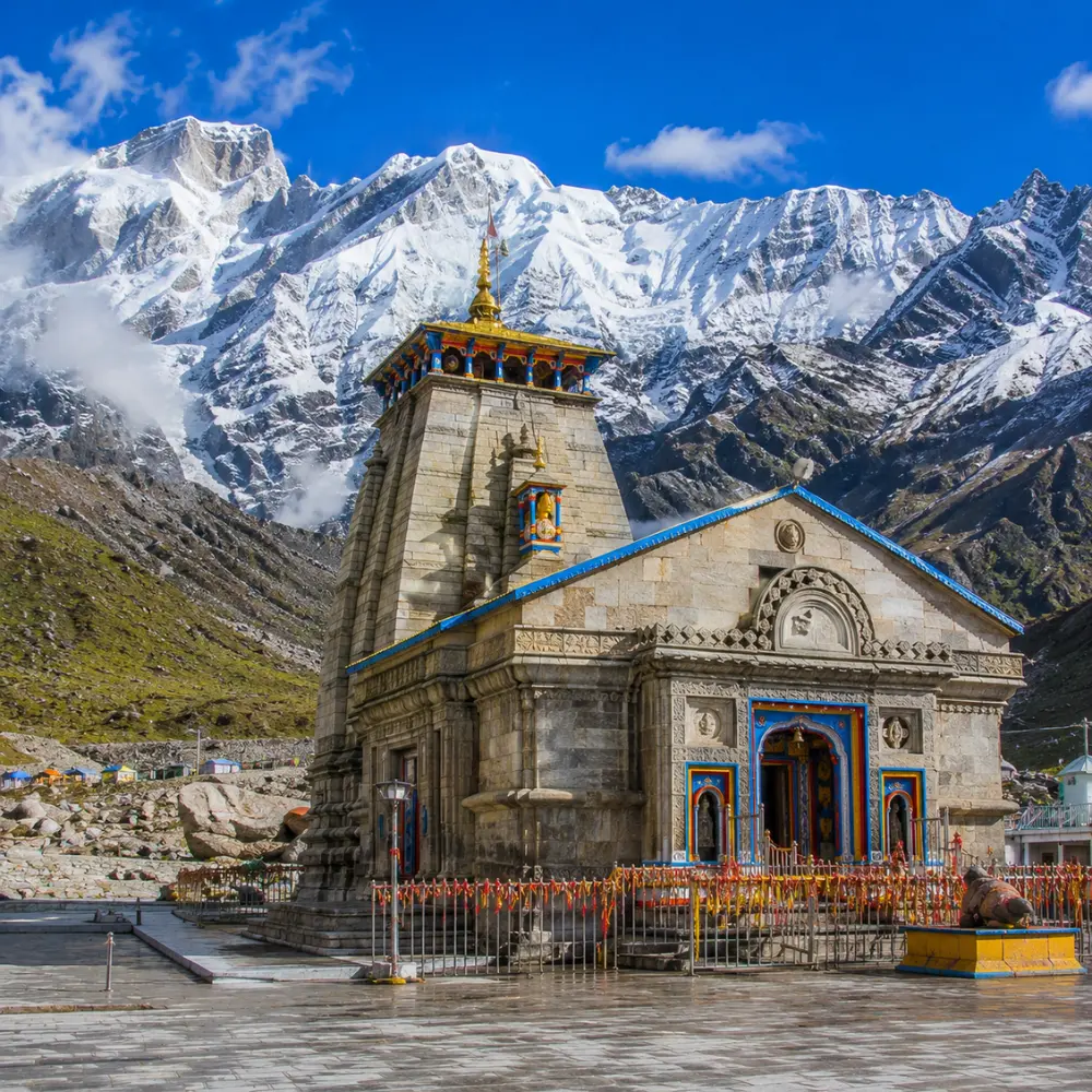 Bright morning view of Kedarnath Temple with snow-covered Himalayan peaks and clear mountain scenery