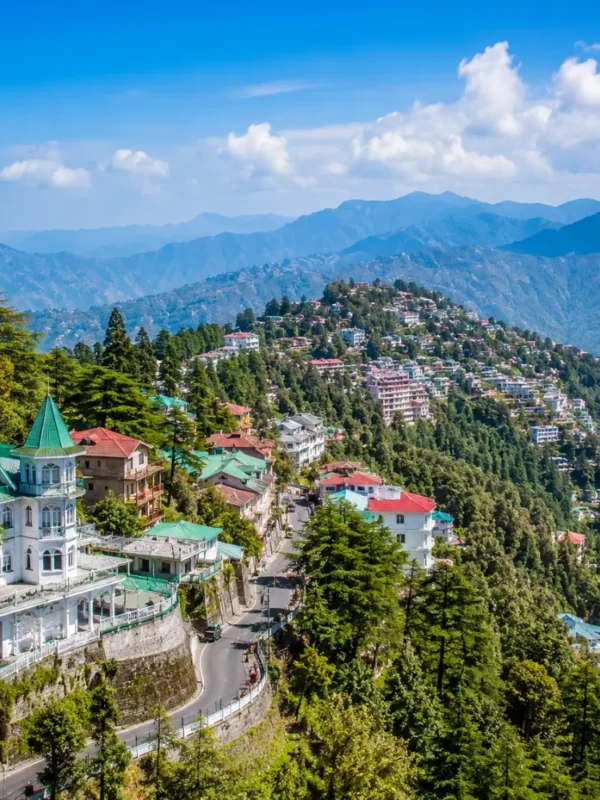 Bright morning view of Mussoorie hill station with green valleys, mountain roads, and clear Himalayan scenery