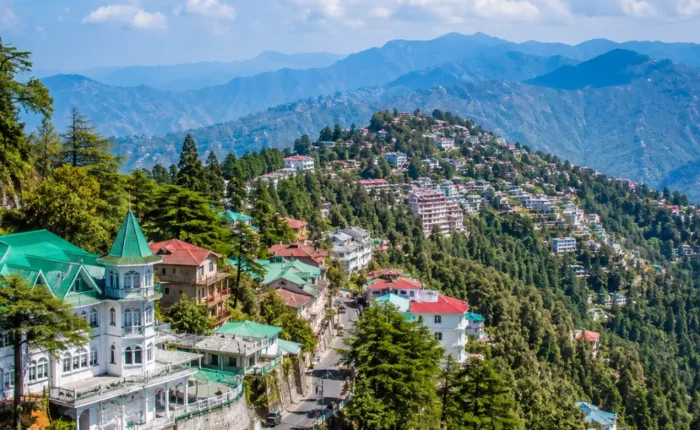 Bright morning view of Mussoorie hill station with green valleys, mountain roads, and clear Himalayan scenery