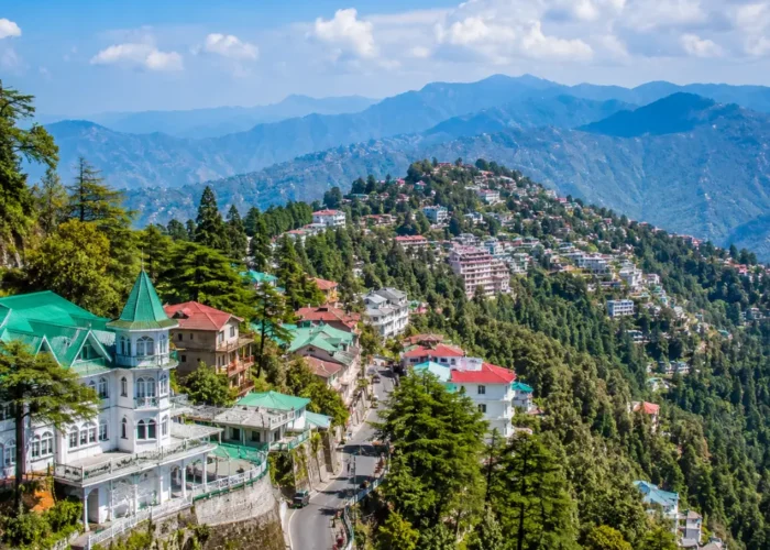 Bright morning view of Mussoorie hill station with green valleys, mountain roads, and clear Himalayan scenery