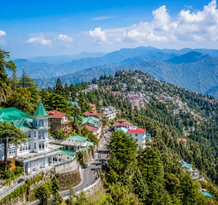 Bright morning view of Mussoorie hill station with green valleys, mountain roads, and clear Himalayan scenery