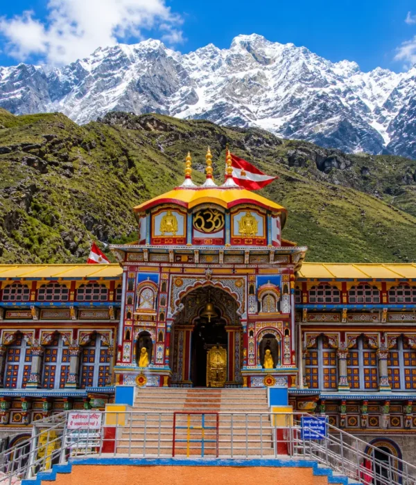 Bright morning view of Badrinath Temple with colorful facade, Himalayan mountains, and clear sacred valley scenery