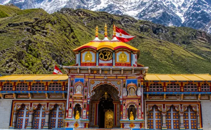 Bright morning view of Badrinath Temple with colorful facade, Himalayan mountains, and clear sacred valley scenery