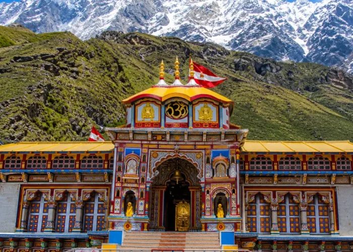 Bright morning view of Badrinath Temple with colorful facade, Himalayan mountains, and clear sacred valley scenery