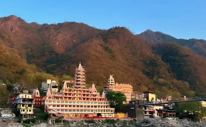 Grand Uttarakhand Explorer tour with riverfront town, mountain backdrop, scenic hills and peaceful Uttarakhand landscape