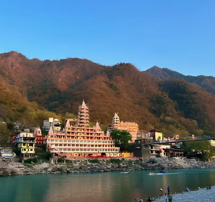 Grand Uttarakhand Explorer tour with riverfront town, mountain backdrop, scenic hills and peaceful Uttarakhand landscape