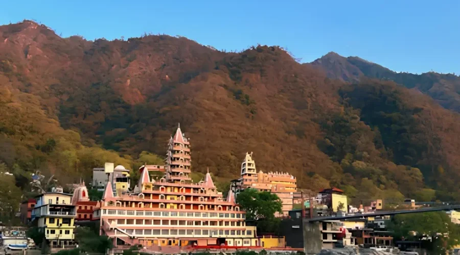 Grand Uttarakhand Explorer tour with riverfront town, mountain backdrop, scenic hills and peaceful Uttarakhand landscape