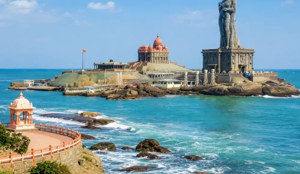 Kanyakumari seashore with Vivekananda Rock Memorial, Thiruvalluvar statue and clear morning ocean views.