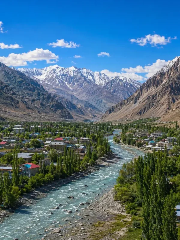 Ultra-realistic Kargil valley landscape with river, green town, snow-capped mountains, and dramatic Himalayan scenery.