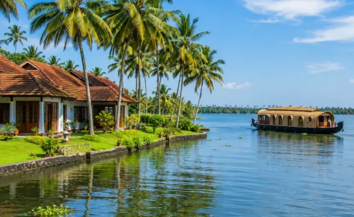 Kumarakom backwaters with calm Vembanad Lake, coconut palms and traditional Kerala village charm in morning light.