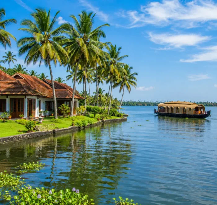 Kumarakom backwaters with calm Vembanad Lake, coconut palms and traditional Kerala village charm in morning light.