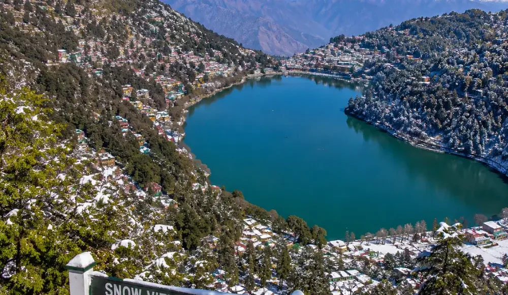 Bright morning view from Snow View Point in Nainital with Himalayan peaks, green hills, and clear mountain scenery
