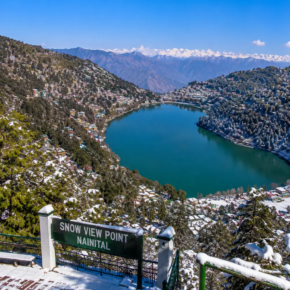 Bright morning view from Snow View Point in Nainital with Himalayan peaks, green hills, and clear mountain scenery