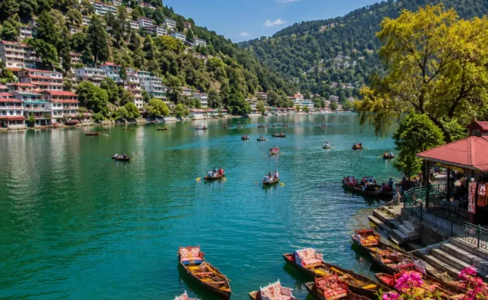 Bright morning view of Naini Lake in Nainital with green hills, clear water, and peaceful mountain scenery