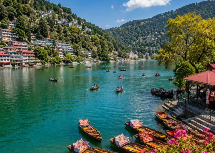 Bright morning view of Naini Lake in Nainital with green hills, clear water, and peaceful mountain scenery