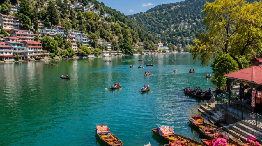 Bright morning view of Naini Lake in Nainital with green hills, clear water, and peaceful mountain scenery