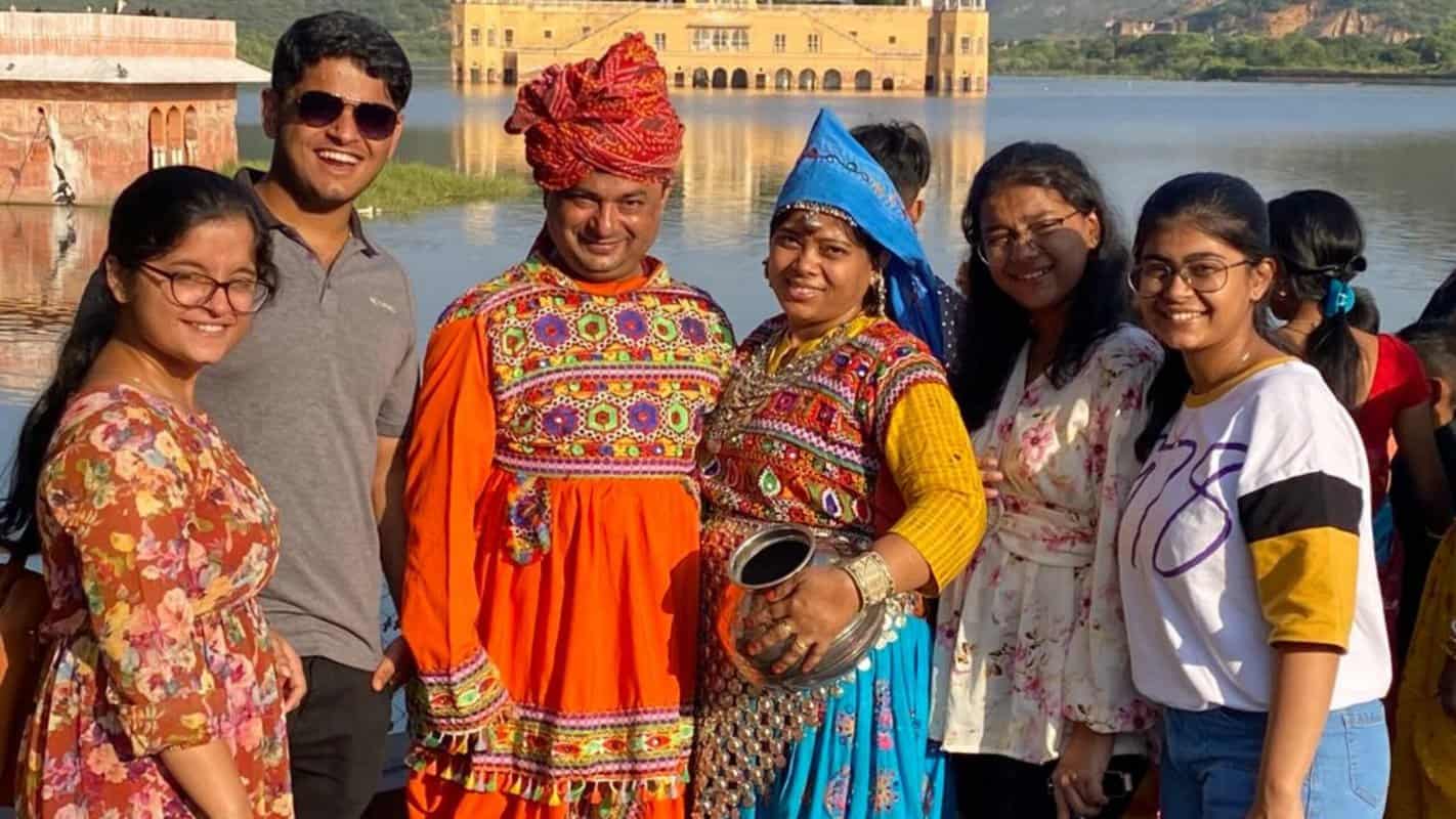 Majestic India tour group enjoying cultural festivities and scenic river views in Rajasthan, capturing authentic Indian heritage and vibrant traditions for ultimate India travel experience.