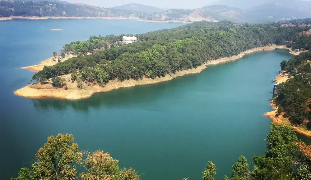 Assam Meghalaya Highlights Package with scenic lake, forested island, rolling hills and peaceful Northeast India landscape