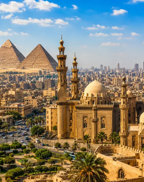 Bright daytime view of Cairo with historic mosque architecture, city skyline, palm trees, and Giza pyramids.