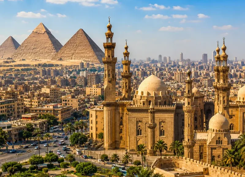 Bright daytime view of Cairo with historic mosque architecture, city skyline, palm trees, and Giza pyramids.