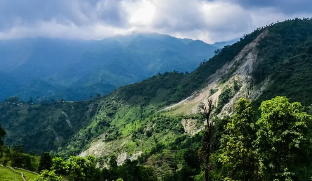 Grand West Bengal Explorer with green hills, cloudy sky, mountain valley and scenic North Bengal nature landscape