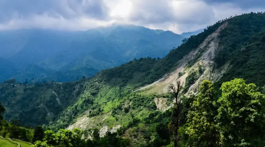 Grand West Bengal Explorer with green hills, cloudy sky, mountain valley and scenic North Bengal nature landscape