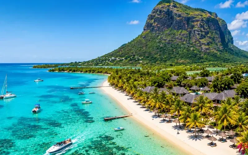 Mauritius tropical beach with turquoise lagoon, luxury shoreline and Le Morne mountain in bright daylight