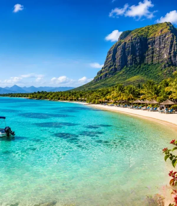 Mauritius beach with turquoise lagoon, palm-lined shoreline, luxury resort and Le Morne mountain in daylight