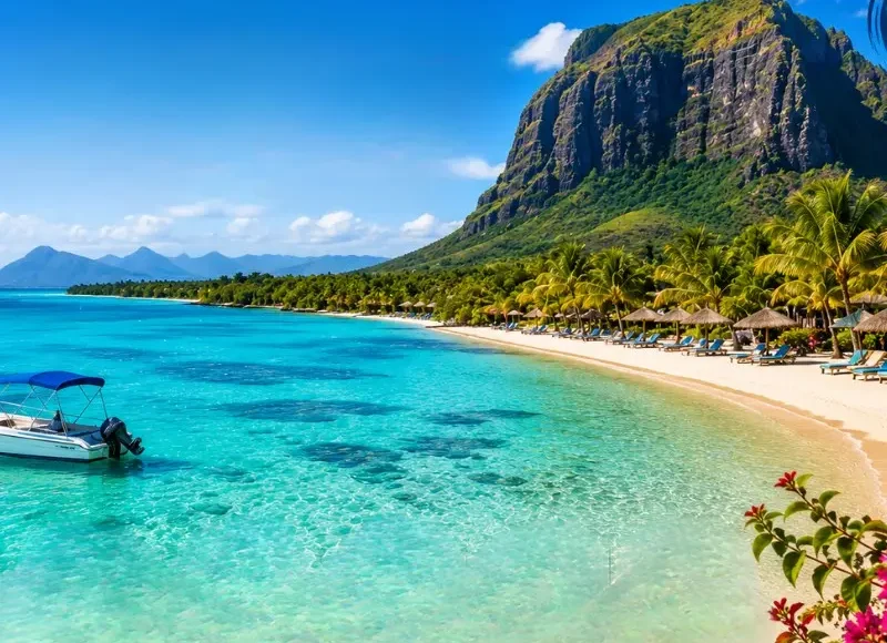 Mauritius beach with turquoise lagoon, palm-lined shoreline, luxury resort and Le Morne mountain in daylight