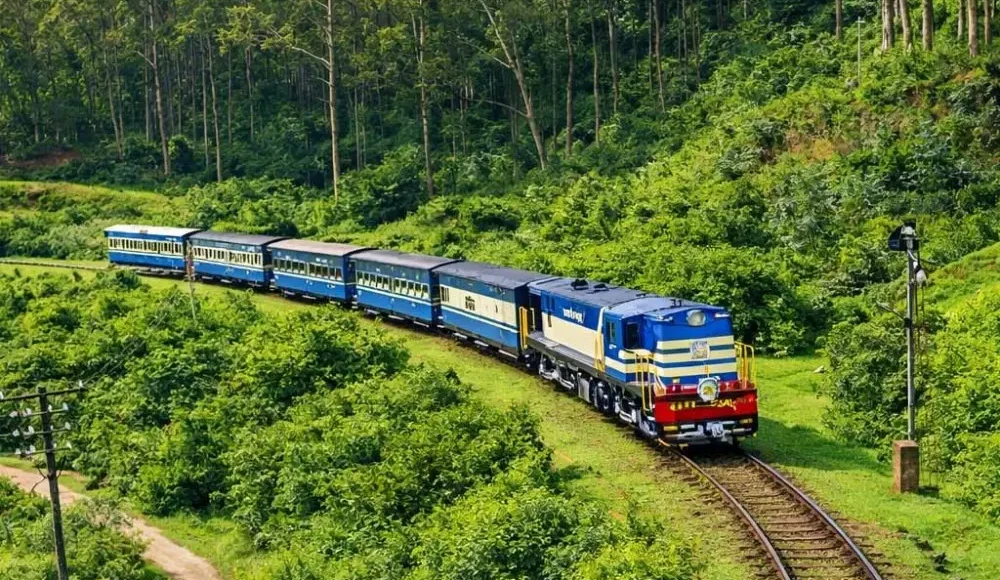Scenic Ooty and Kodaikanal tour image featuring a blue hill train passing through lush green forest landscapes