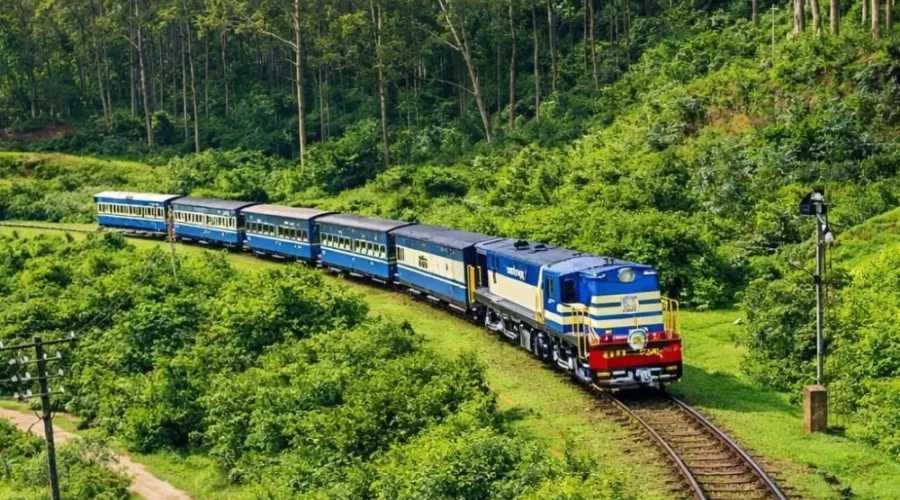 Scenic Ooty and Kodaikanal tour image featuring a blue hill train passing through lush green forest landscapes