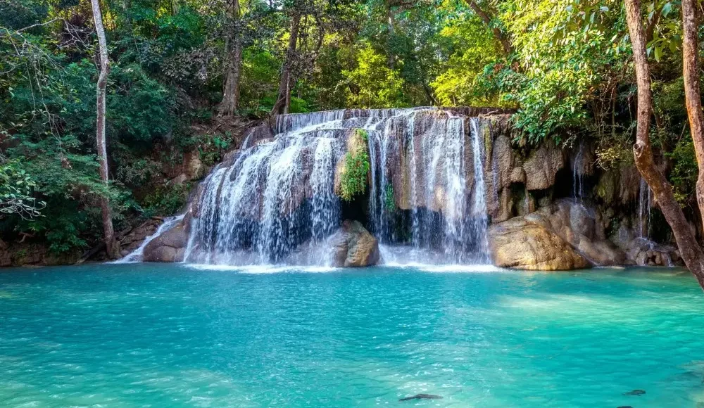 Pachmarhi hill station package image featuring a scenic waterfall and turquoise natural pool surrounded by lush forest
