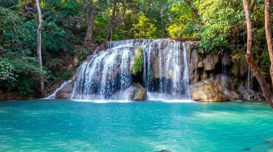 Pachmarhi hill station package image featuring a scenic waterfall and turquoise natural pool surrounded by lush forest