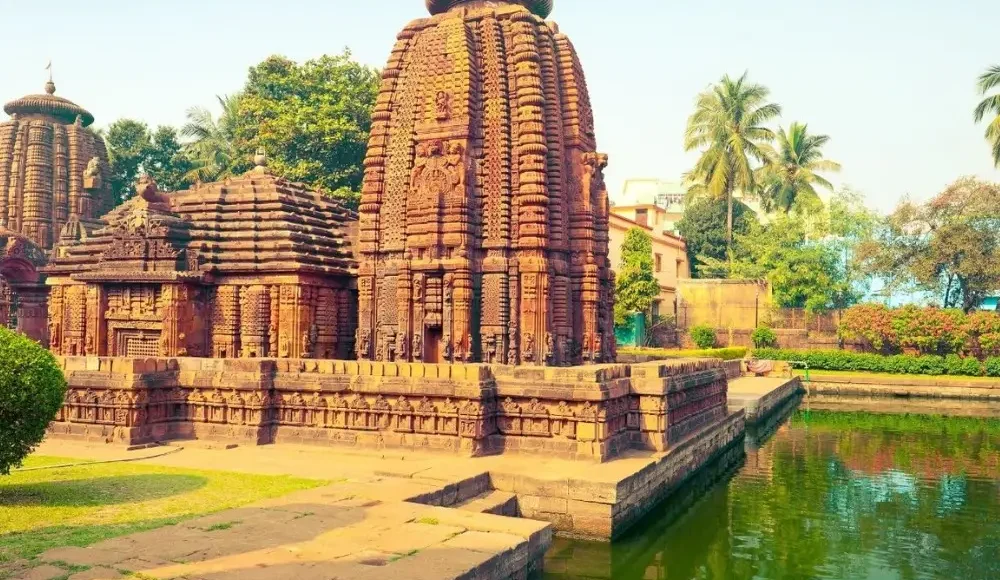 Puri Konark Chilika package image showing an ancient Odisha temple beside a serene water tank and lush greenery