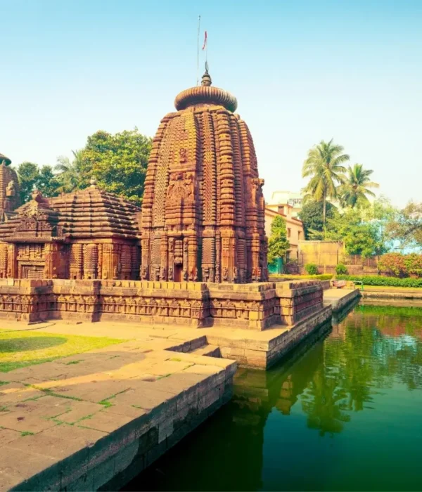 Puri Konark Chilika package image showing an ancient Odisha temple beside a serene water tank and lush greenery
