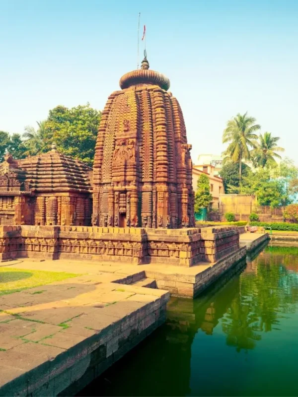 Puri Konark Chilika package image showing an ancient Odisha temple beside a serene water tank and lush greenery