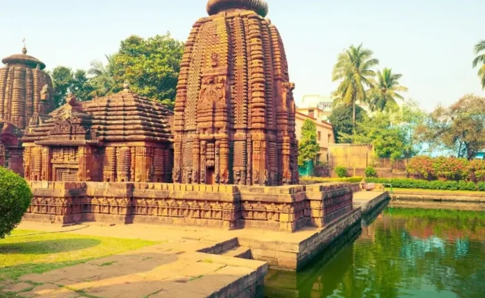 Puri Konark Chilika package image showing an ancient Odisha temple beside a serene water tank and lush greenery