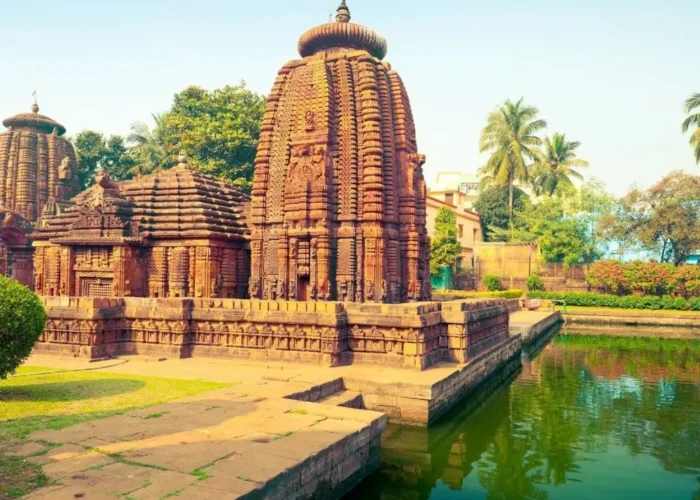 Puri Konark Chilika package image showing an ancient Odisha temple beside a serene water tank and lush greenery