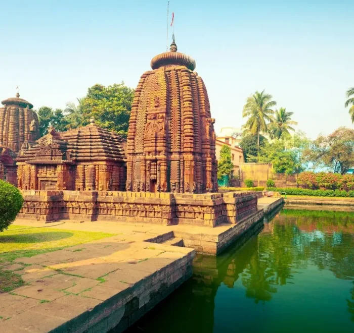 Puri Konark Chilika package image showing an ancient Odisha temple beside a serene water tank and lush greenery