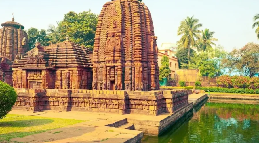 Puri Konark Chilika package image showing an ancient Odisha temple beside a serene water tank and lush greenery