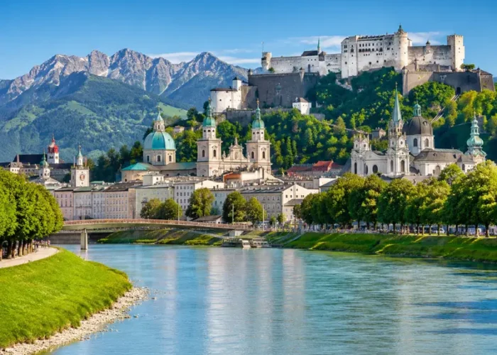Luxury daytime view of Salzburg, Austria with Hohensalzburg Fortress, Salzach River, churches, and alpine mountains.