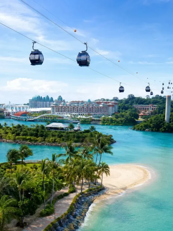 Sentosa Island Singapore with cable cars, turquoise sea, palm beach, and resort skyline in bright morning light.