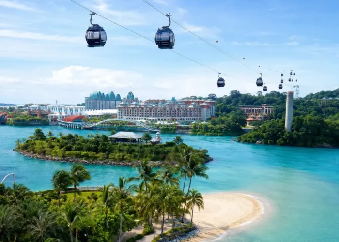 Sentosa Island Singapore with cable cars, turquoise sea, palm beach, and resort skyline in bright morning light.