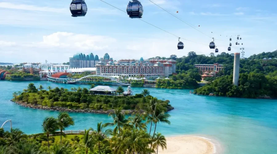 Sentosa Island Singapore with cable cars, turquoise sea, palm beach, and resort skyline in bright morning light.