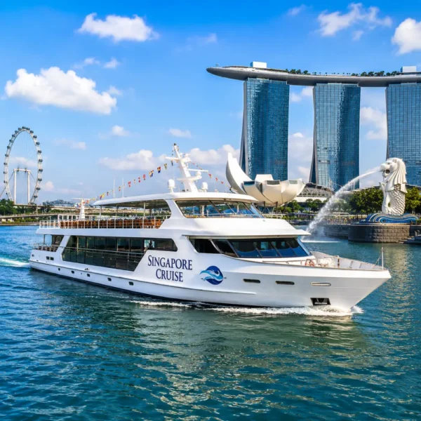 Luxury Singapore cruise ship near Marina Bay with skyline, blue water, and bright morning travel atmosphere.