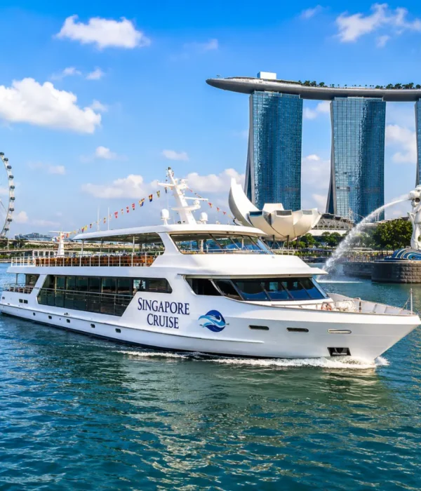 Luxury Singapore cruise ship near Marina Bay with skyline, blue water, and bright morning travel atmosphere.