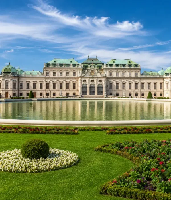 Luxury daytime view of Vienna’s Belvedere Palace with formal gardens, reflecting pool, and elegant Baroque architecture.