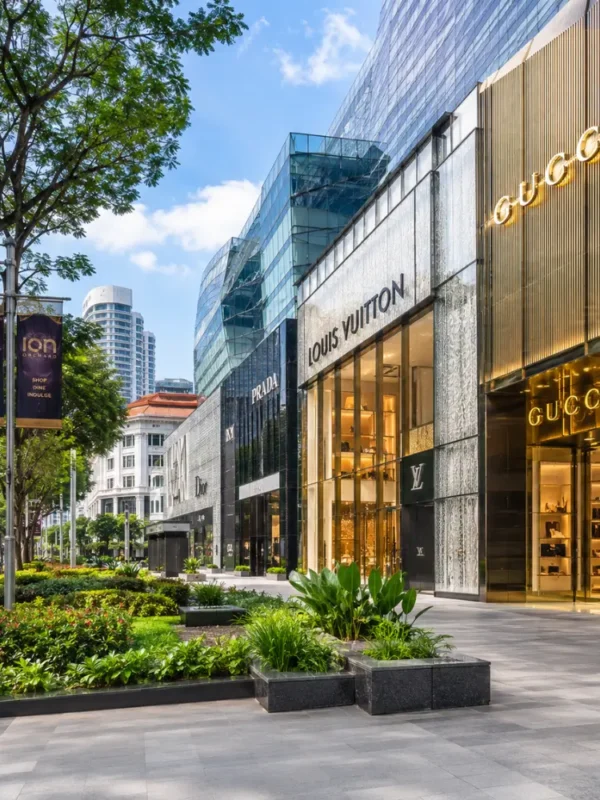 Luxury shopping street in Singapore with Marina Bay style skyline, designer stores, and bright morning atmosphere.