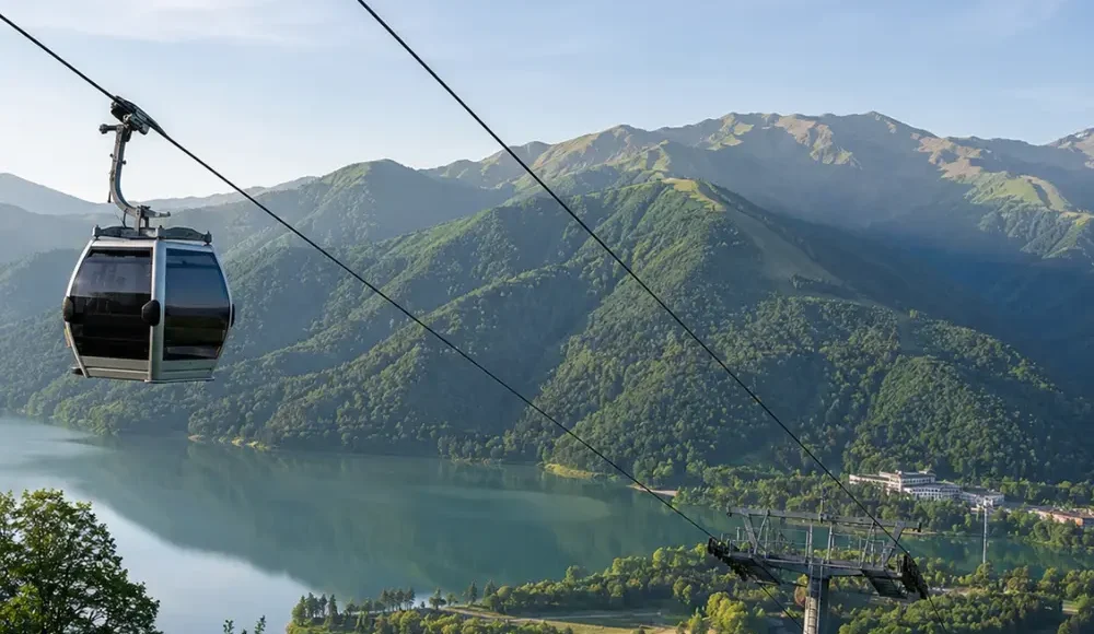 Gabala Azerbaijan mountain landscape with cable car, green valleys, calm lake, and bright morning atmosphere